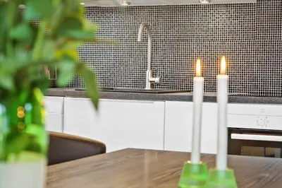 two candles sitting on a table in a kitchen at 169-Thisted-Fiskervej-69 in Thisted