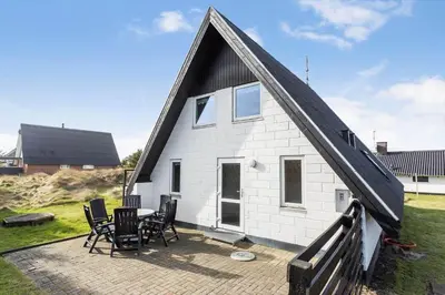 a white house with chairs and a table on a patio at 169-Thisted-Fiskervej-69 in Thisted