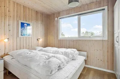 a bedroom with a bed covered in blankets at 658-Thisted-Laksevej-8 in Thisted