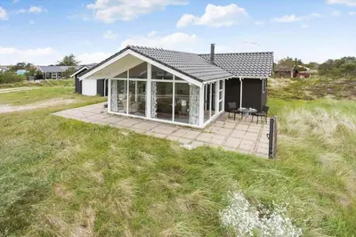 a small house with a deck in a field at 994-Thisted-Gravsesvej-20 in Torsted