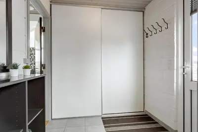a pivot door in a hallway with white walls at 994-Thisted-Gravsesvej-20 in Torsted