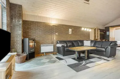 a living room with a leather couch and a table at 648-Thisted-Kuttervej-8 in Thisted