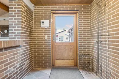 a wooden door in a brick wall with a window at 648-Thisted-Kuttervej-8 in Thisted