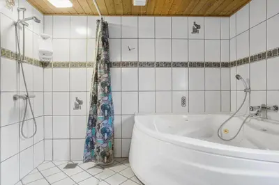 a white bathroom with a tub and a shower at 648-Thisted-Kuttervej-8 in Thisted