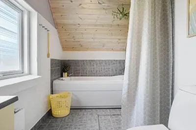 a bathroom with a tub and a shower curtain at 326-Thisted-Kristinesvej-24 in Thisted