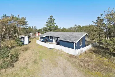 a blue house on the side of a hill at 329-Thisted-Sandtornvej-21 in Thisted