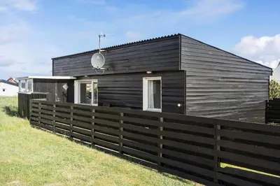 a black house with a fence in front of it at 790-Thisted-Nordsovej-90 in Thisted