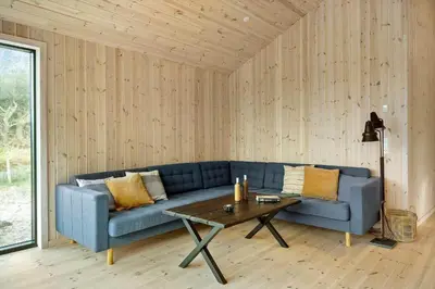 a living room with a blue couch and a table at 113-Thisted-Muslingevej-13-D in Thisted