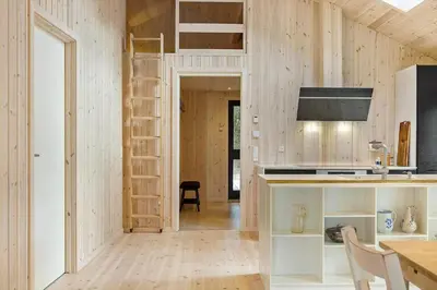a tiny house with a kitchen and a loft bed at 113-Thisted-Muslingevej-13-D in Thisted
