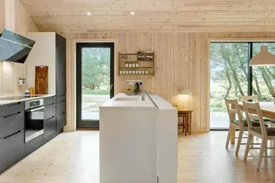 a kitchen with a white counter and a table at 113-Thisted-Muslingevej-13-D in Thisted