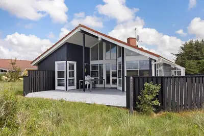 a black and white house with a deck at 546-Thisted-Kuttervej-16 in Thisted