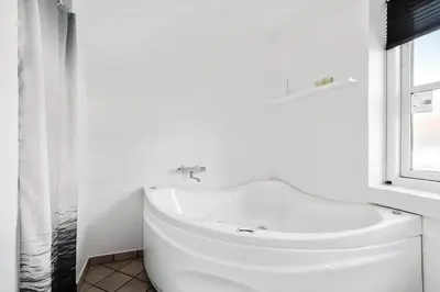 a white bathroom with a sink and a window at 161-Hanstholm-Kraegpotvej-161 in Hanstholm