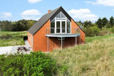 a small house with a balcony on the side of it at 161-Hanstholm-Kraegpotvej-161 in Hanstholm