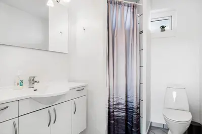 a bathroom with a sink and a toilet and a shower at 161-Hanstholm-Kraegpotvej-161 in Hanstholm