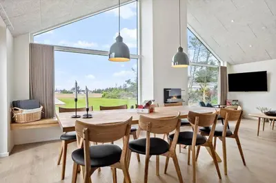 a dining room with a table and chairs and a large window at 667-Thisted-Smedevej-3-C in Thisted