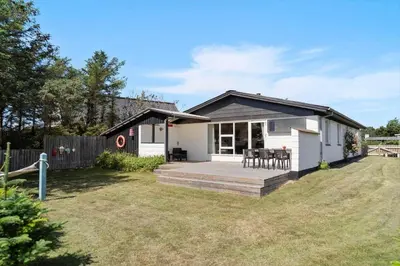 a small white house with a deck in a yard at 804-Thisted-Aerenprisvej-14 in Thisted