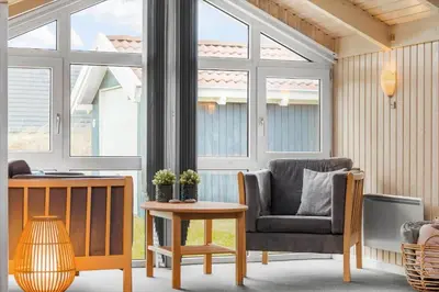 a living room with a chair and a table at 772-Thisted-Hummervej-6 in Thisted