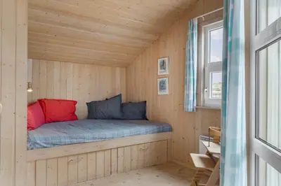 a bed in a tiny house with a window at 947-Thisted-Niels-Vognmands-Vej-20 in Torsted