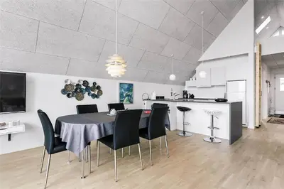 a dining room and kitchen with a table and chairs at 793-Thisted-Havstokken-24-1 in Thisted