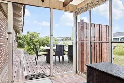 an open patio with a table and chairs on a deck at 685-Thisted-Pighvarvej-28 in Thisted