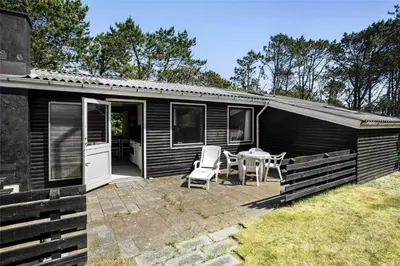 a cabin with a patio and a table and chairs at 982-Thisted-Clemmessti-16 in Torsted
