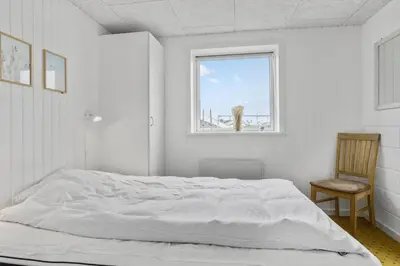 a white bedroom with a bed and a window at 867-Thisted-Nordsovej-66 in Thisted