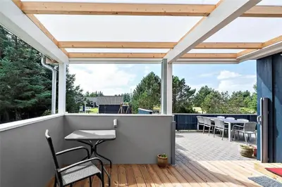 a patio with a table and chairs on a deck at 618-Thisted-Fiskervej-82 in Thisted