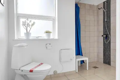 a white bathroom with a toilet and a window at 618-Thisted-Fiskervej-82 in Thisted