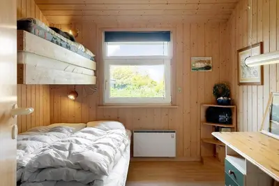 a bedroom with a bed in a room with a window at 165-Thisted-Laksevej-5 in Thisted