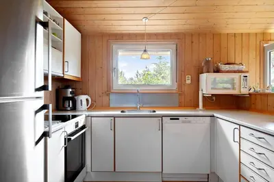 a kitchen with white cabinets and a window at 165-Thisted-Laksevej-5 in Thisted