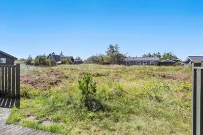 a field of grass with houses in the background at 165-Thisted-Laksevej-5 in Thisted