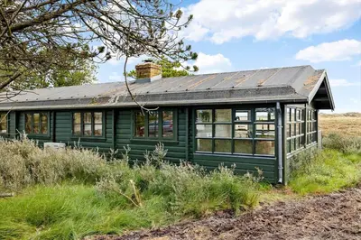 a green house with a metal roof in a field at 1307-Bedsted-Thy-Nordre-Redningsvej-4 in Bedsted Thy
