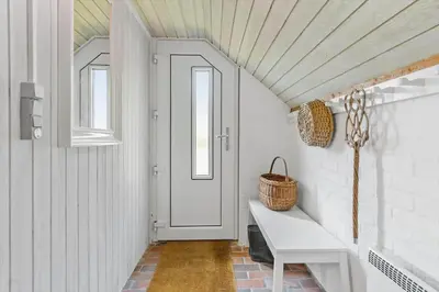 a hallway with a white door and a white bench at 641-Snedsted-Istrupvej-21-C in Snedsted