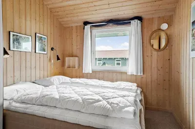 a bedroom with a white bed and a window at 940-Thisted-Spanggardsvej-45 in Torsted