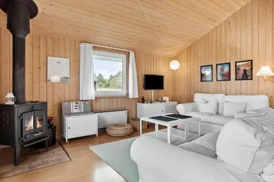 a living room with a couch and a stove at 940-Thisted-Spanggardsvej-45 in Torsted