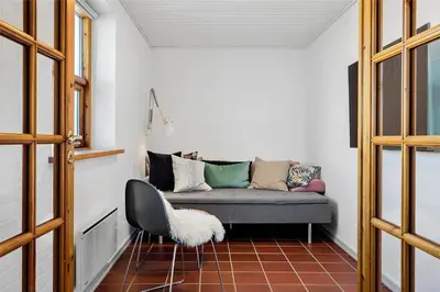 a living room with a couch and a chair at 917-Thisted-Kobbelsti-46 in Torsted