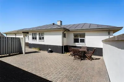 a house with a patio with a table and chairs at 917-Thisted-Kobbelsti-46 in Torsted
