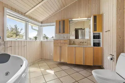 a bathroom with a tub and a sink at 709-Thisted-Muslingevej-2 in Thisted