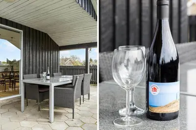 a bottle of wine sitting next to a wine glass at 855-Thisted-Flyndervej-5 in Thisted