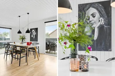 a kitchen and a dining room with a table with flowers at 855-Thisted-Flyndervej-5 in Thisted