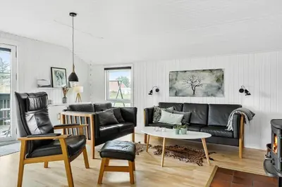 a living room with a couch and a table at 855-Thisted-Flyndervej-5 in Thisted