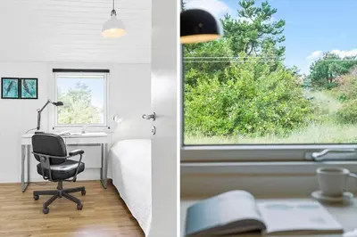 a bedroom with a bed and a desk and a window at 855-Thisted-Flyndervej-5 in Thisted