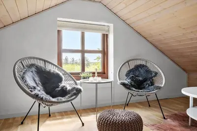 two chairs and a table in a room with a window at 490-Snedsted-Niels-Juels-Vej-39 in Snedsted