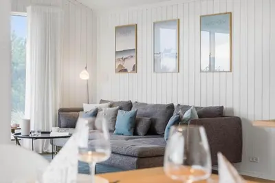 a living room with a couch and a table with wine glasses at 1056-Thisted-Johns-Vej-16 in Torsted