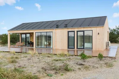 a house with a solar roof on a wooden deck at 1056-Thisted-Johns-Vej-16 in Torsted