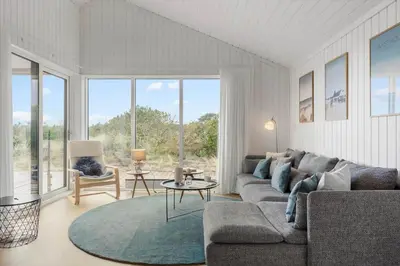a living room with a couch and a large window at 1056-Thisted-Johns-Vej-16 in Torsted