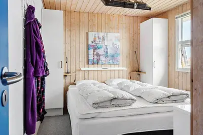 a bedroom with a bed with white sheets and pillows at 1039-Thisted-Niels-Vognmands-Vej-19 in Torsted