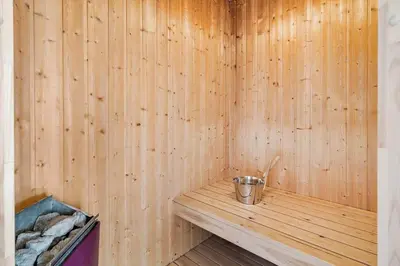 a sauna with a bucket on a wooden bench at 1039-Thisted-Niels-Vognmands-Vej-19 in Torsted
