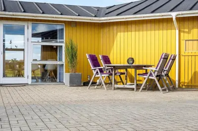 four purple chairs and a table in front of a yellow wall at 1039-Thisted-Niels-Vognmands-Vej-19 in Torsted