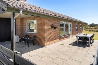 a patio with a table and chairs and a building at 234-Thisted-Kuttervej-9 in Thisted